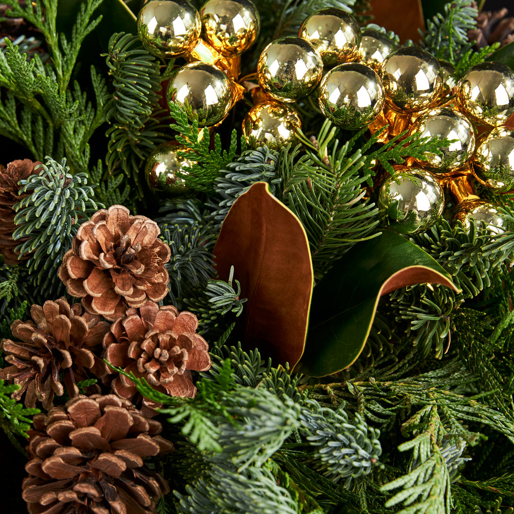 
                  
                    Cedar, Pine, Pine Cones, Magnolia Leaves and gold balls.
                  
                