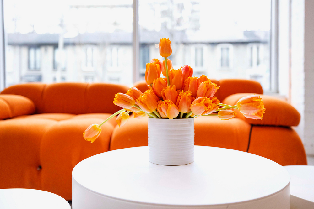 Orange tulip arrangements displayed at the SkinCeuticals event