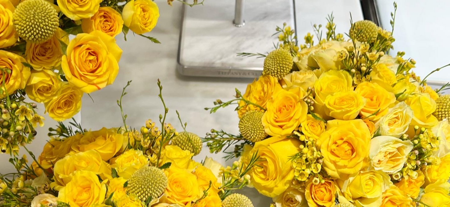 Yellow rose floral arrangements displayed at Tiffany & Co